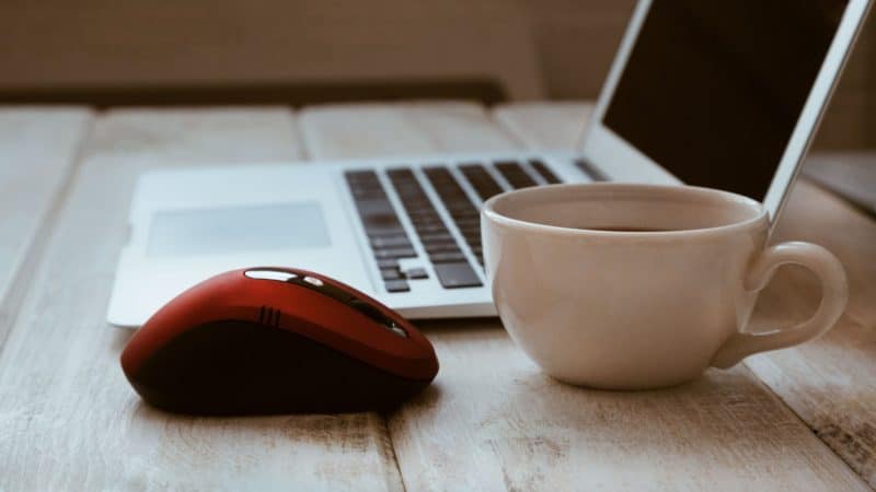 Computer mouse, coffee, and laptop.