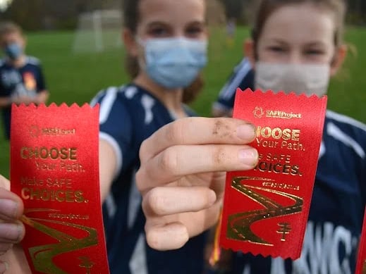 Photo with children holding red ribbons